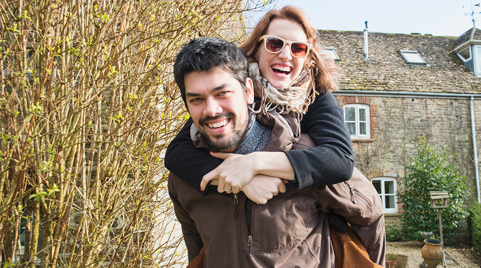 Man giving woman piggy back